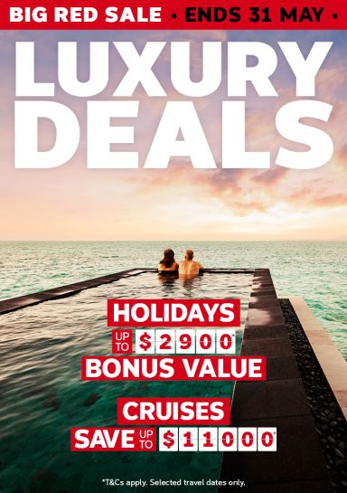 Couple relaxing in an infinity pool at sunset for a Big Red Sale with luxury holiday bonus value up to $2900 and cruises saving up to $11000
