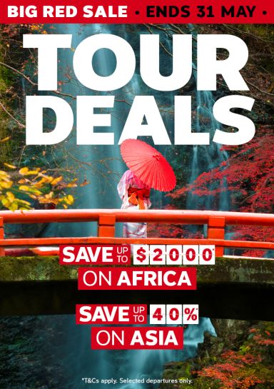 Person in a kimono with a red parasol on a red bridge in Japan for a Big Red Sale tour deals saving up to $2000 on Africa and 40% on Asia