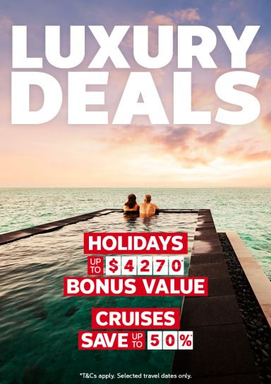 Couple in an infinity pool gazing at a calm ocean sunset for luxury deals with up to $4270 bonus value on holidays and save up to 50% on cruises