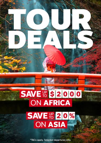 Person in a kimono with a red parasol on a Japanese bridge in autumn for tour deals saving up to $2000 on Africa and up to 20% on Asia tours
