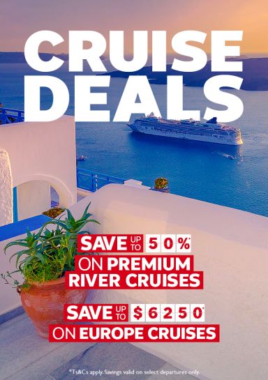 Cruise ship off white-washed Santorini at sunset for cruise deals saving up to 50% on premium river cruises or up to $6250 on Europe cruises