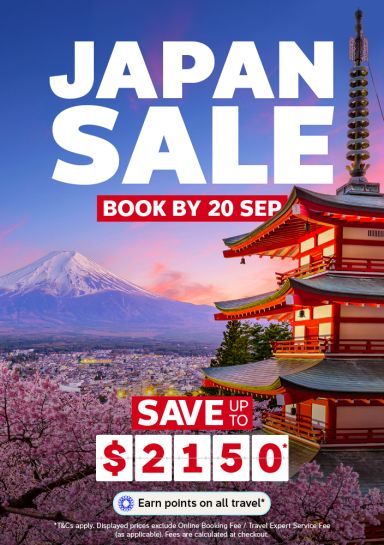 Snow capped Mount Fuji framed by cherry blossoms and a red pagoda at sunset for a Japan sale saving up to 2150 dollars
