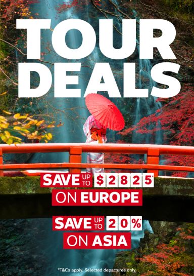 Woman in a kimono with a red parasol on a bridge before an autumn waterfall for tour deals saving 2825 dollars on Europe and 20% on Asia