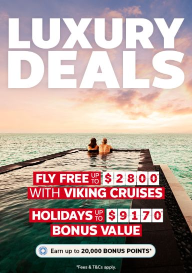 Couple relaxing in oceanfront infinity pool overlooking turquoise sea for Flight Centre luxury deals featuring Viking Cruises fly free up to $2800 bonus