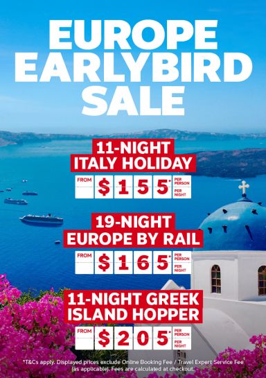 Wide shot of a cruise ship sailing past Santorini featuring Europe earlybird deals