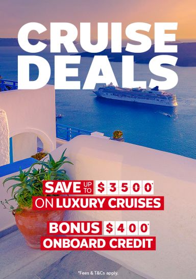 Cruise ship sailing past white Santorini buildings at sunset for cruise deals saving up to 3500 on luxury cruises with 400 dollars onboard credit