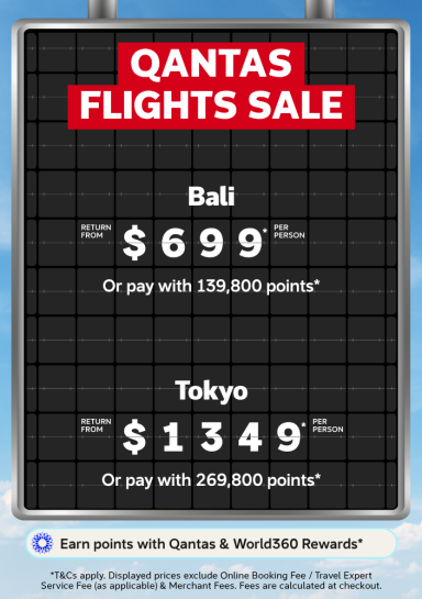 Airport departure board featuring a Qantas flight sale with return flights to Bali from $699 and return flights to Tokyo from $1,349