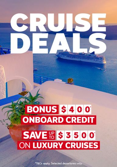 Cruise ship sailing past Santorini whitewashed cliffs at sunset for cruise deals with 400 onboard credit and saving up to 3500 on luxury cruises
