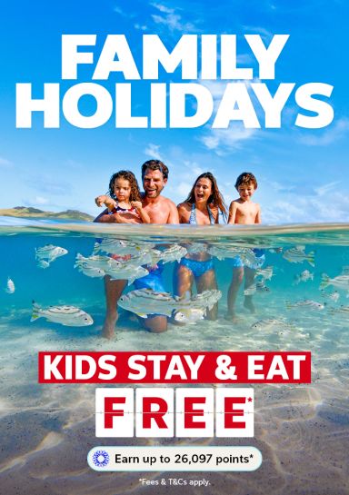 Family of four playing in the ocean featuring family holidays where kids stay & eat free