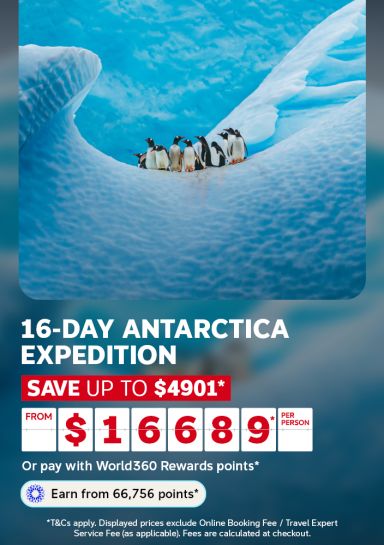 Penguins huddled together on a towering blue iceberg for a 16-day Antarctica expedition saving up to 4901 from 16689 per person