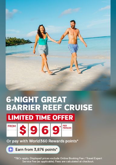 Couple holding hands walking along a tropical beach for a 6-night Great Barrier Reef cruise limited time offer from 969 per person