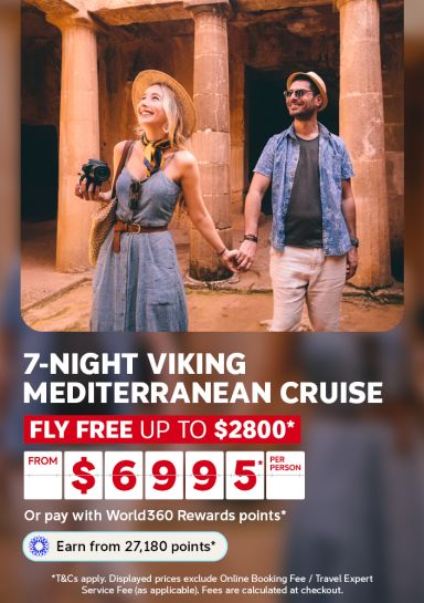 Couple exploring ancient stone ruins hand in hand for a 7-night Viking Mediterranean cruise flying free saving up to 2800 from 6995 per person