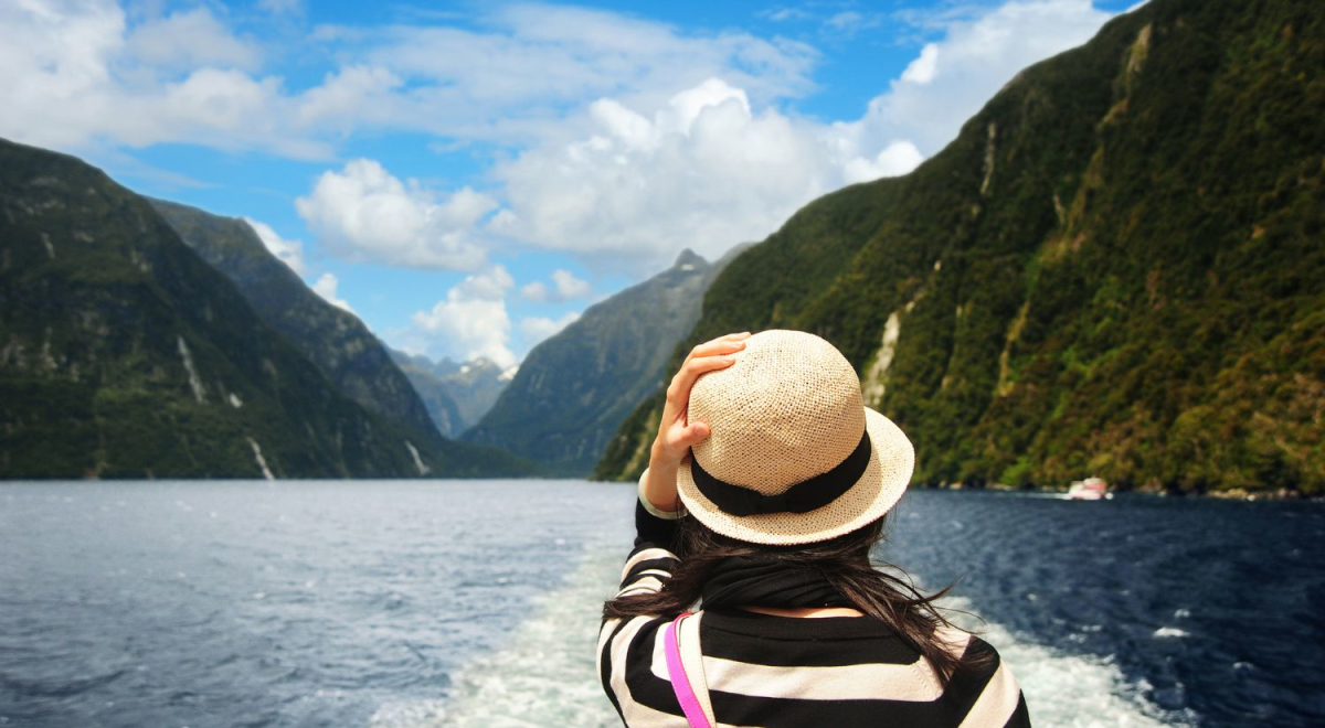 A young woman looking over the railing of a boat