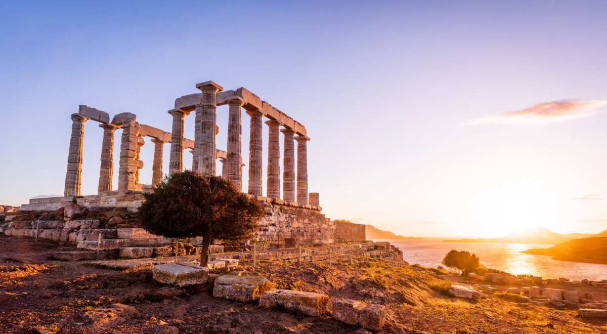 Ancient ruins in Athens as the sun sets in the background