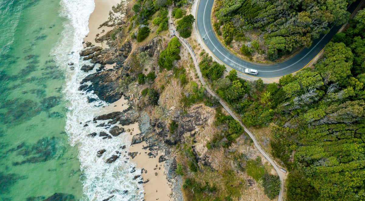 Rocky outcrop into ocean with road 