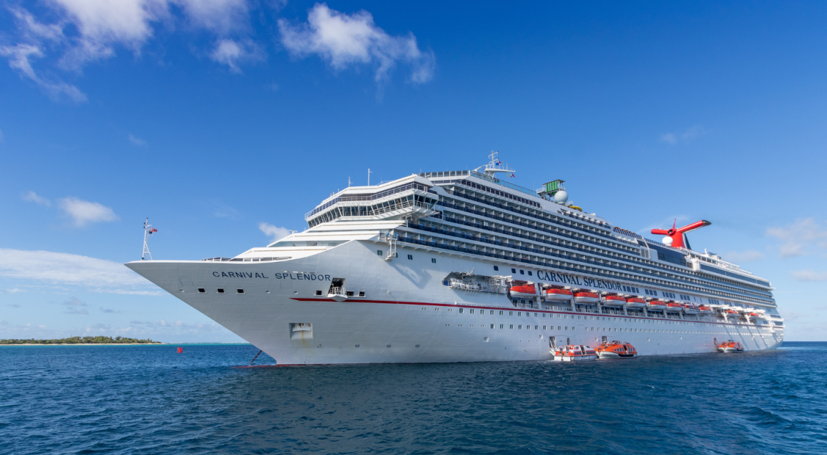 Cruise ship Carnival Splendor moored off a tropical island