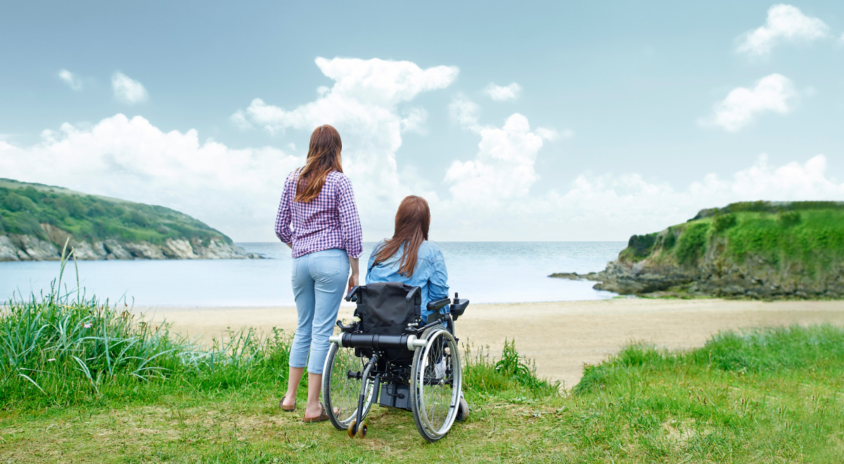 Two women looking out at a beautiful beach landscape