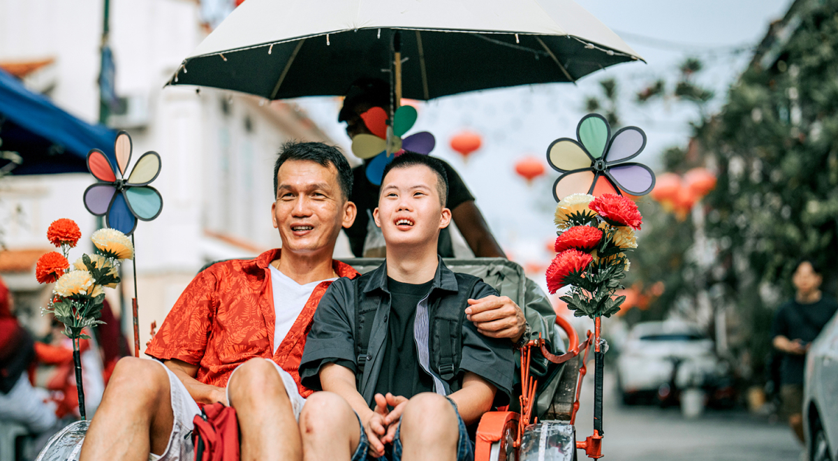 Two travellers in a trishaw in Malaysia