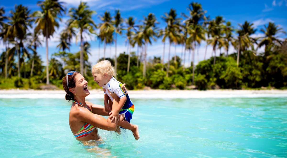 A mother and young child playing on a beach in Vietnam