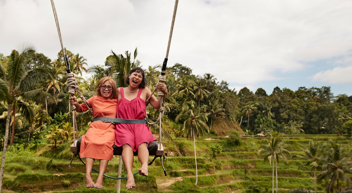 Mother and daughter on a swing in Bali, Indonesia