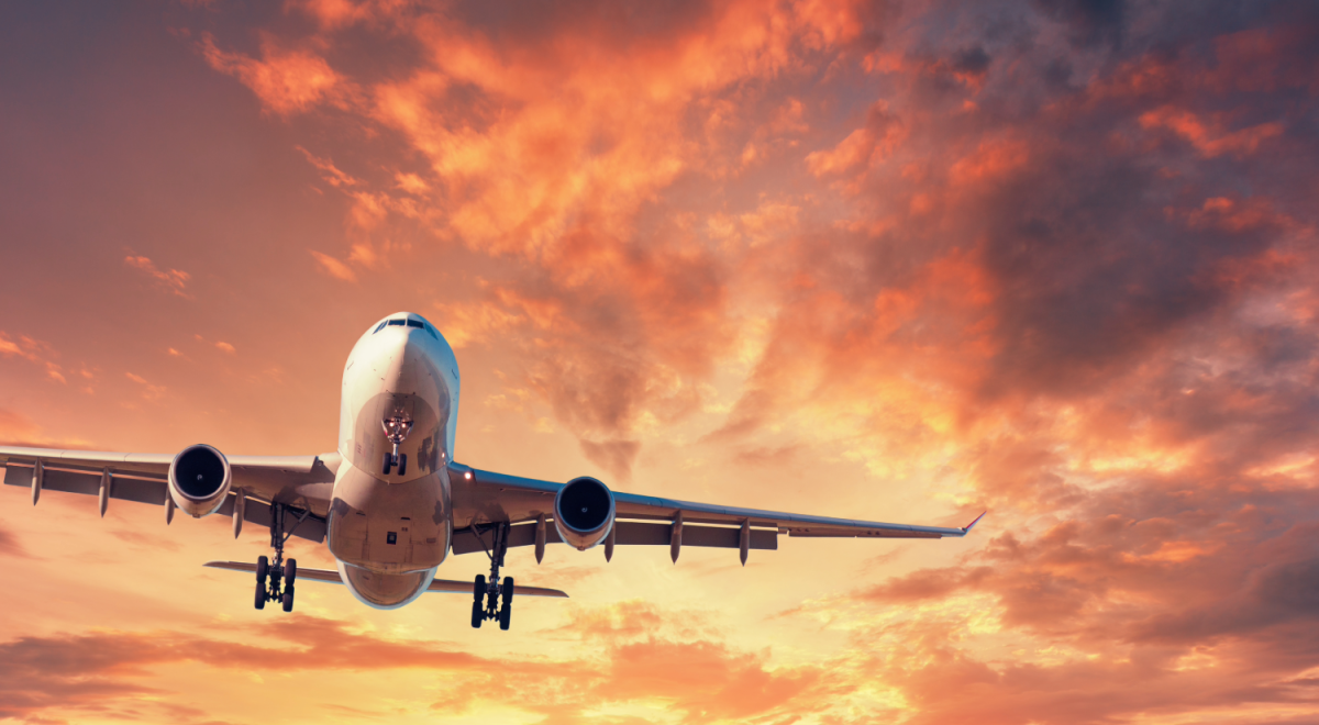 An airliner lands at sunset