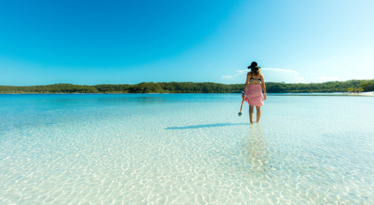 Single Person standing in shallow clear water looking out