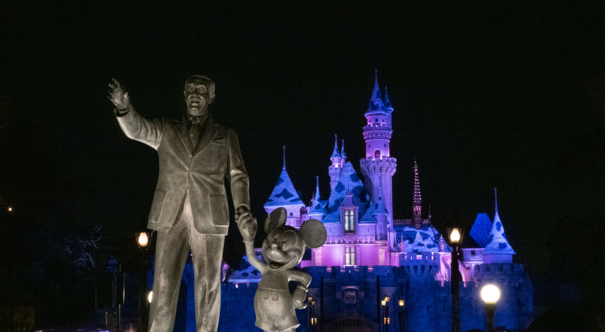 walt disney and mickey statue disneyland at night