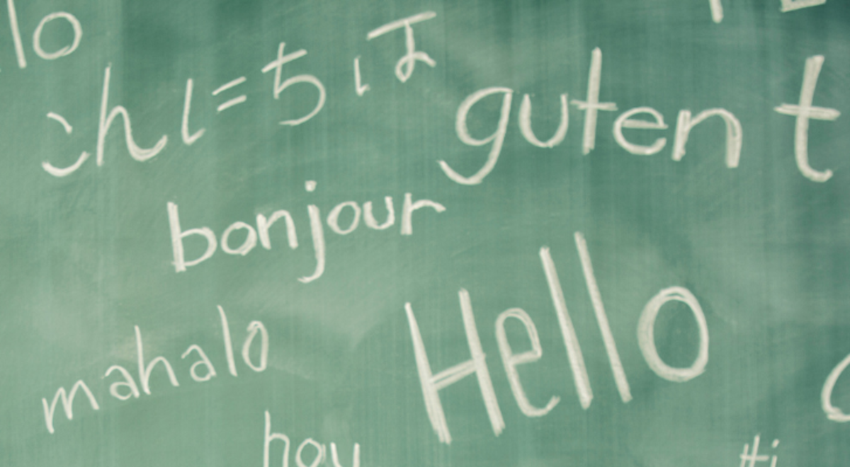 "Hello" written on a chalkboard and translated into different languages