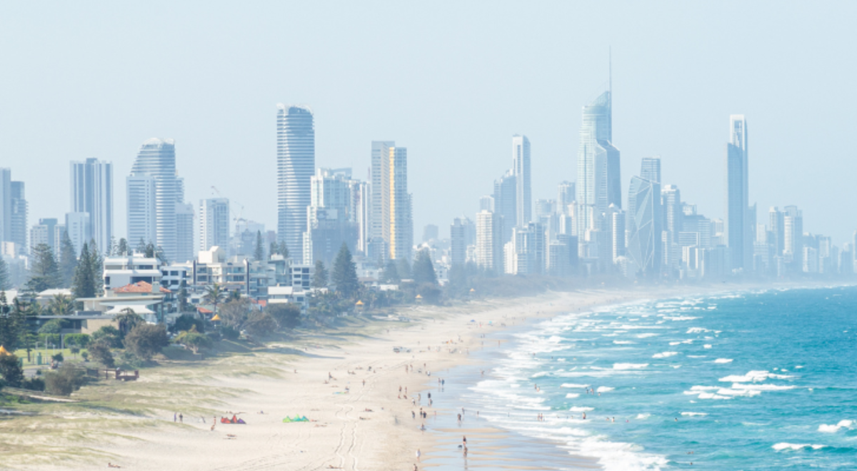 People on the beach with skyscrapers in the background
