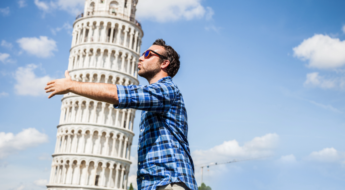 Young tourist having fun in Pisa close to the leaning tower.