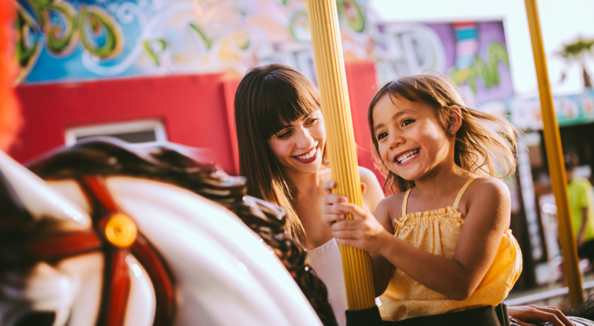 Mother and daughter on carousel ride