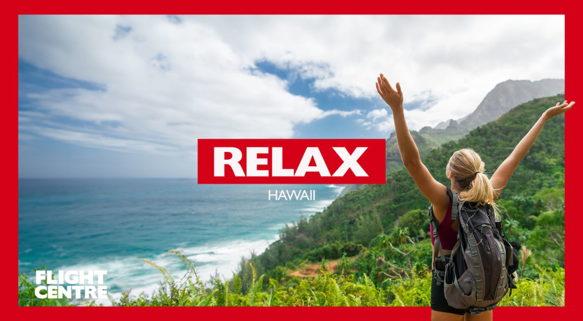 A person overlooking a beach with her hands in the air