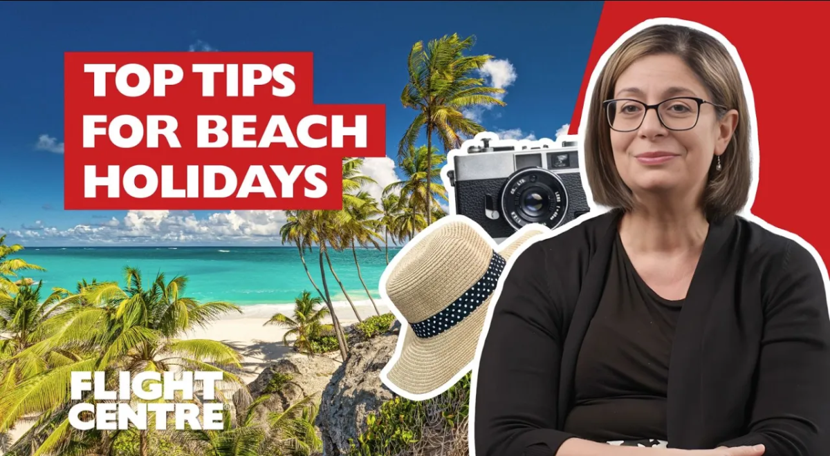 Woman sitting next to a tropical beach