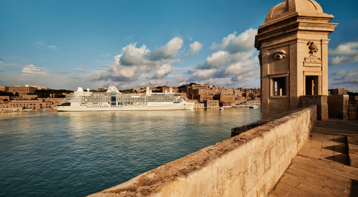 A luxury cruise ship docked in a charming coastal town of the Mediterraean