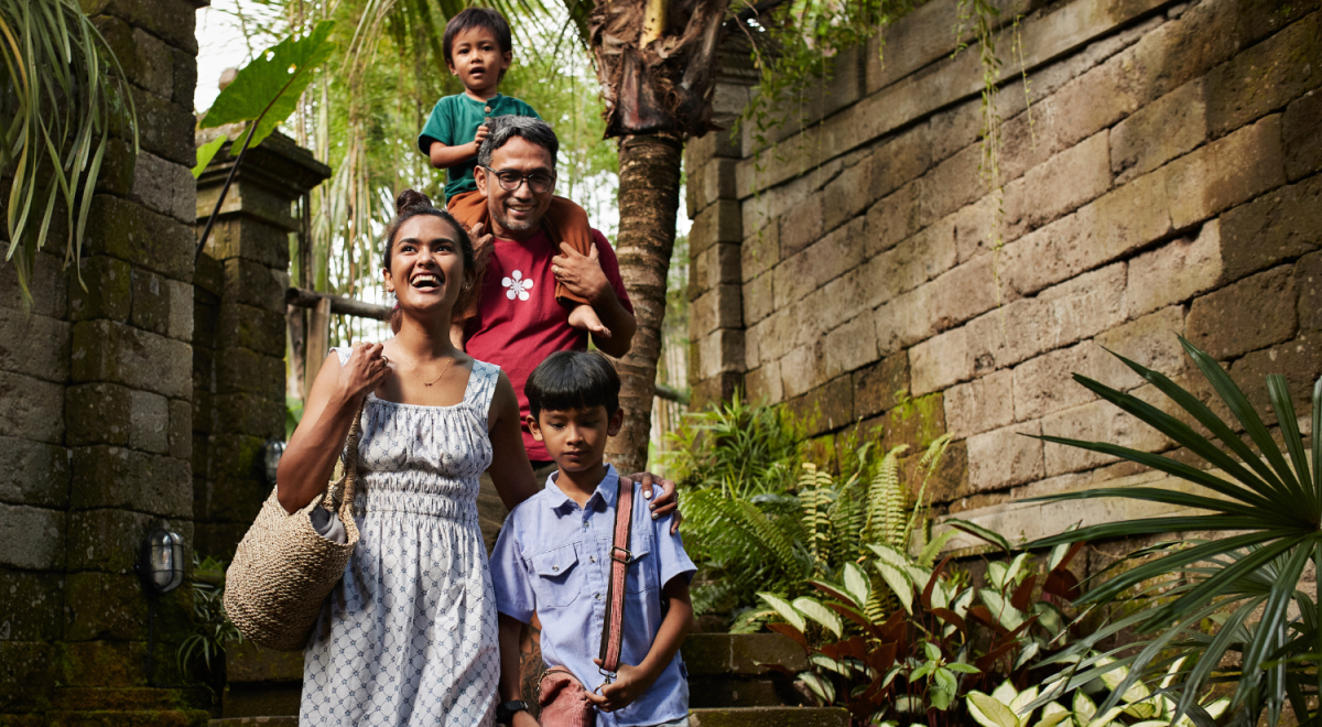 family in asia walking down steps to villa