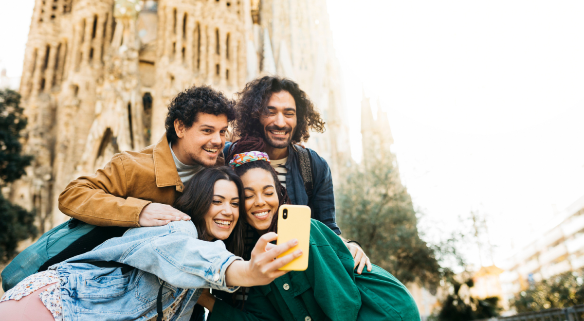 group of tourists taking selfie in front of landmark in Barcelona