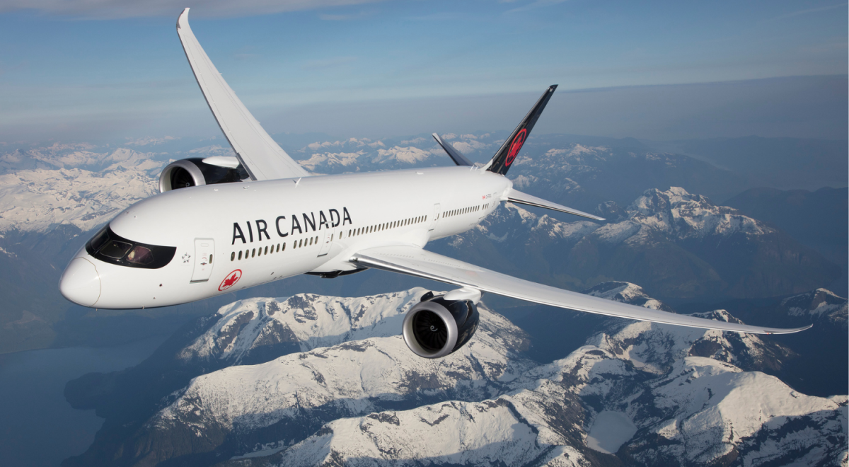 air canada plane flying over the rockies