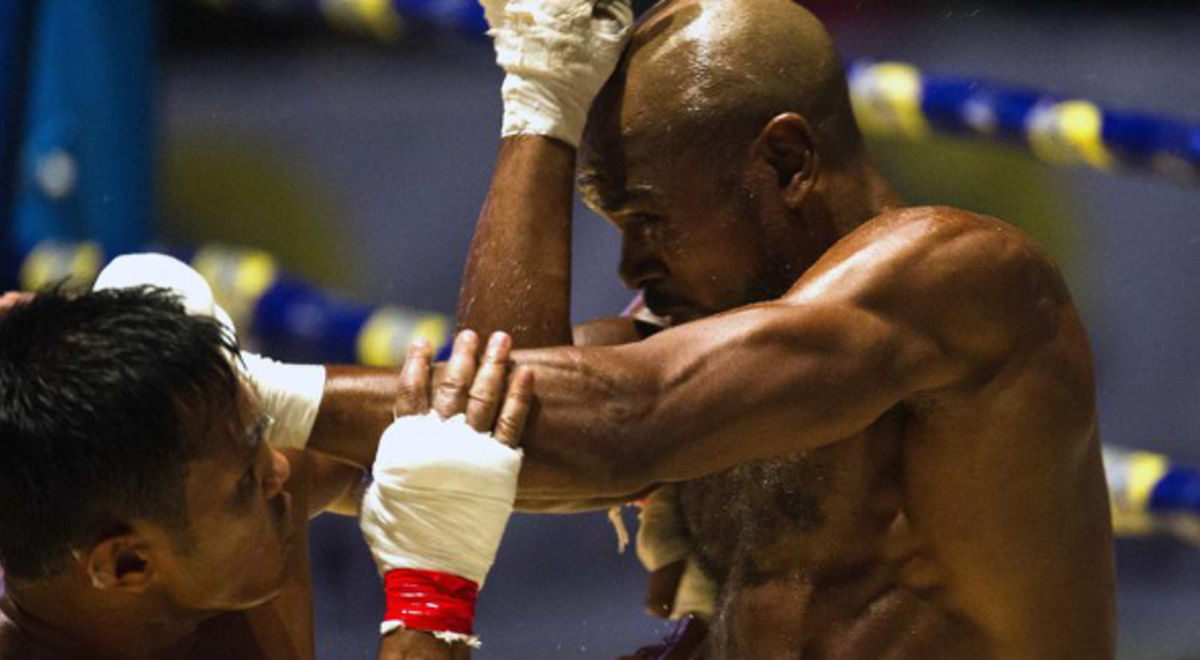 two boxers fighting each other in the ring