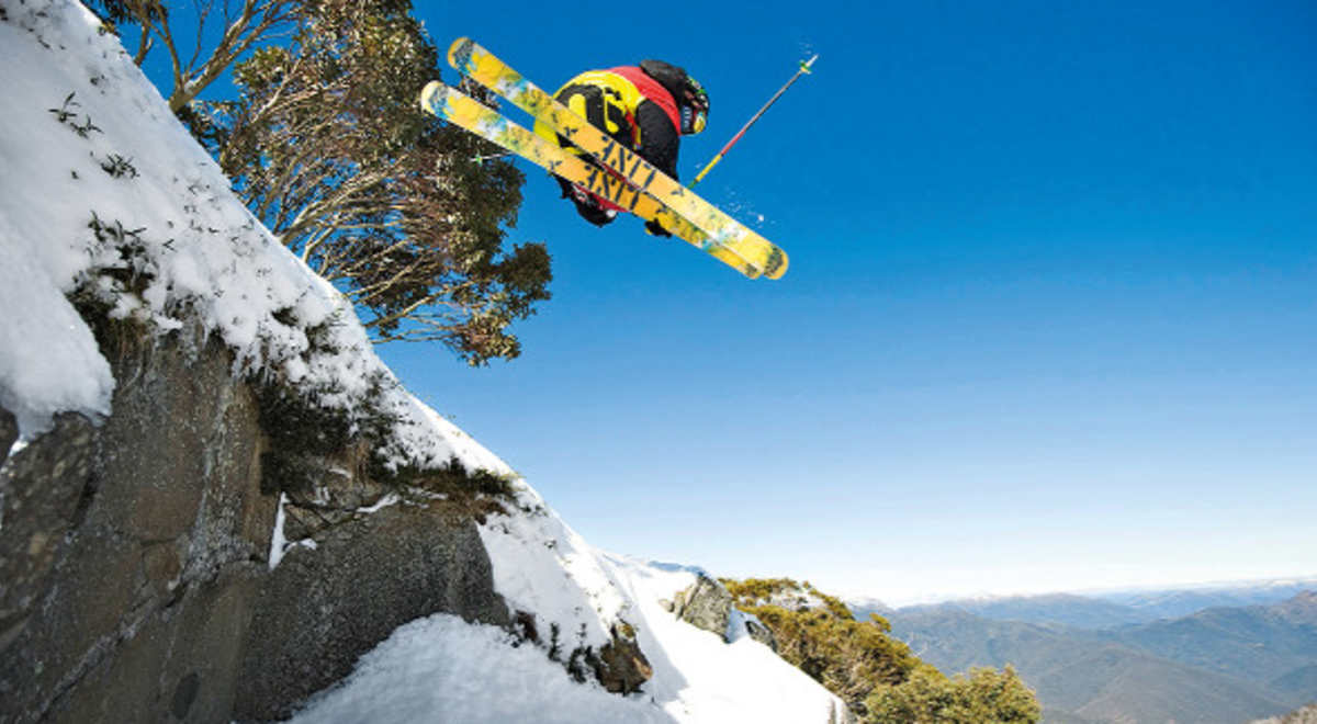 a man skiing at the edge of the snowy mountain