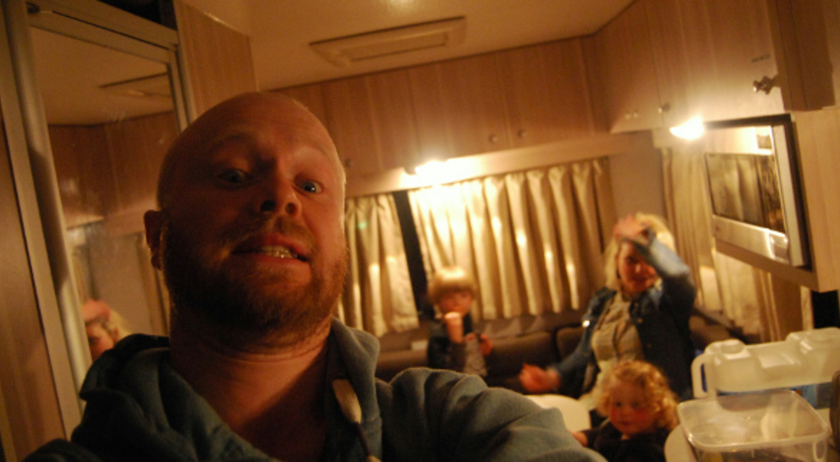 family enjoying dinner camping