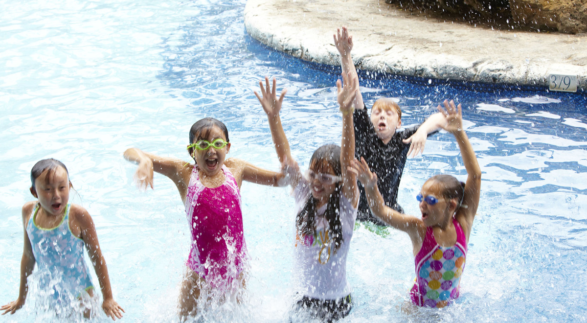 Children happily playing in the pool