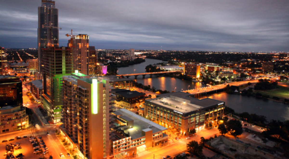 Austin cityscape and river lit up at night 