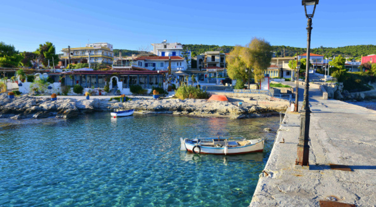 Clear blue water and village in Aegina, Greece 