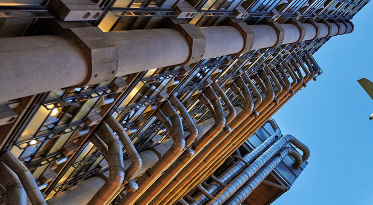 View from the ground of a plane flying over buildings 