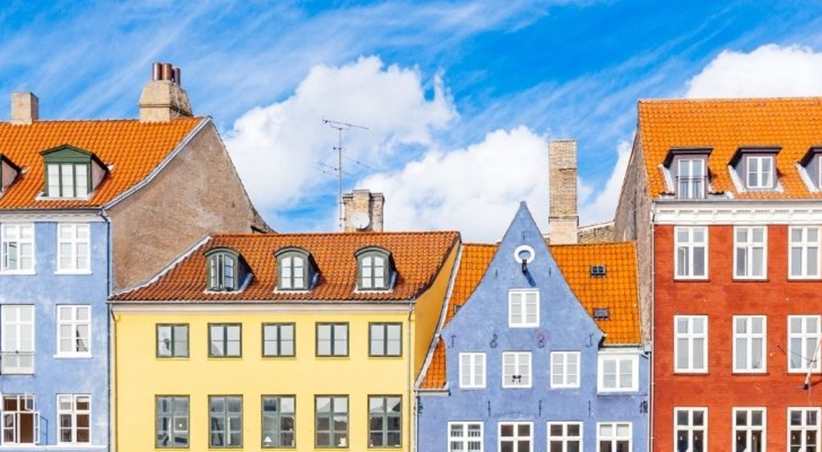Multiple houses in different colors located in  Nyhavn Harbor