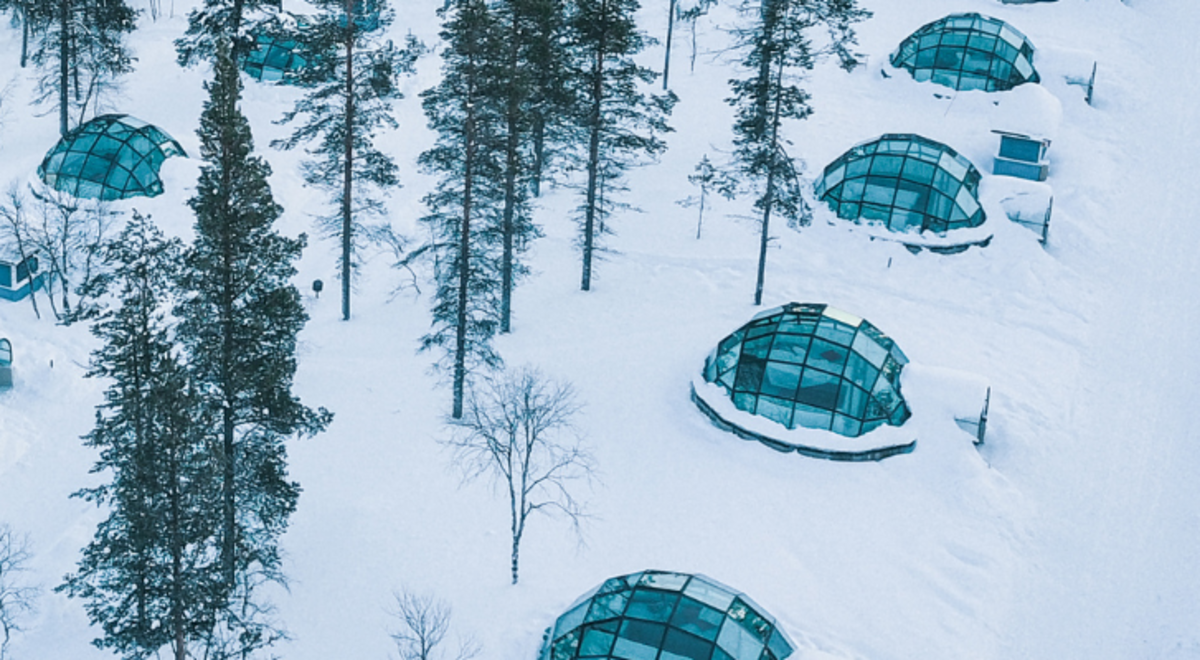 Kakslauttanen Arctic Resort East Village, glass made tents surrounded by snow in the middle of the forest