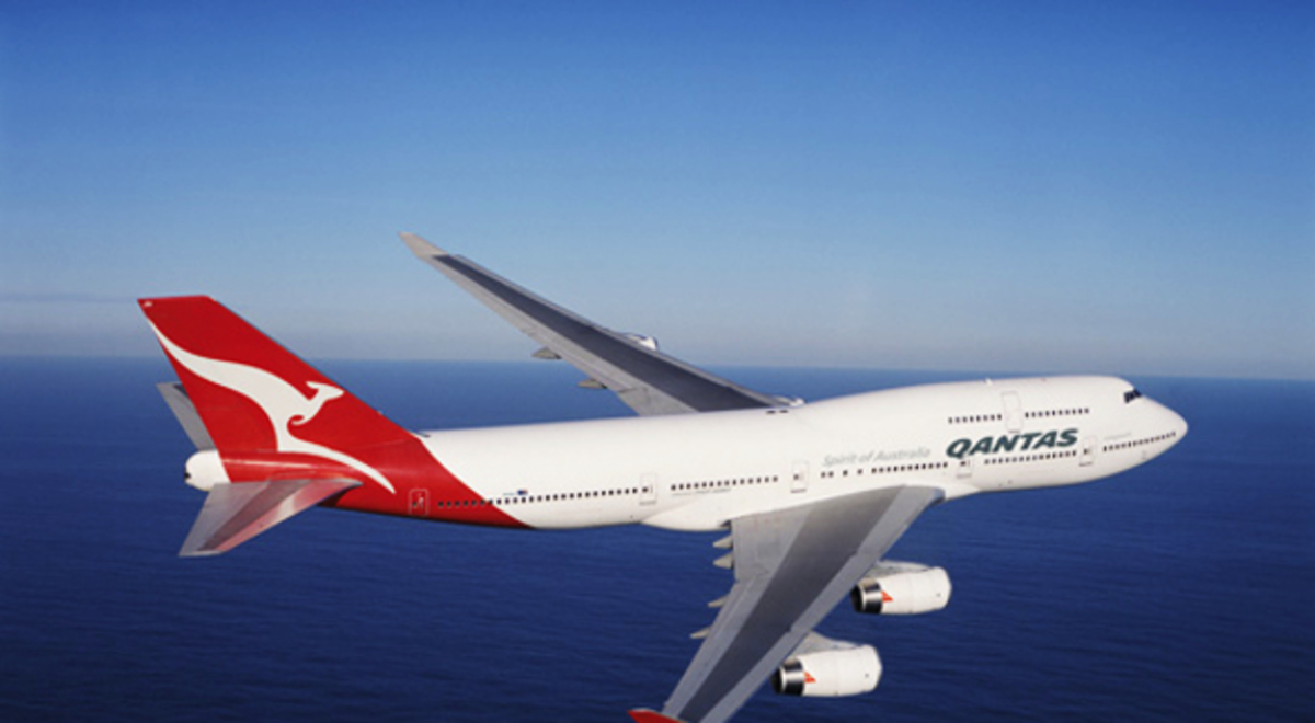 Qantas' airplane soaring across the sea