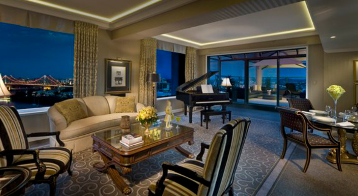 Inside the formal living and dining room with green accents at night 