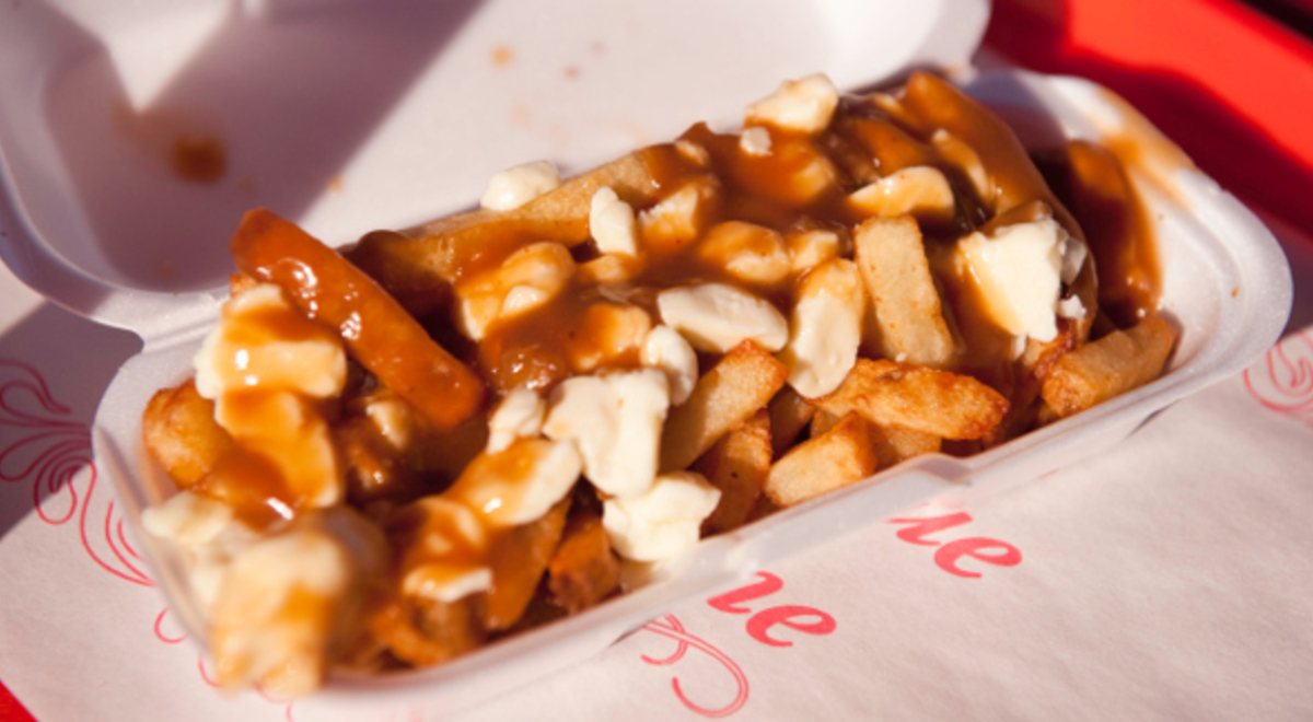Loaded fries with poutine and gravy in a takeaway container