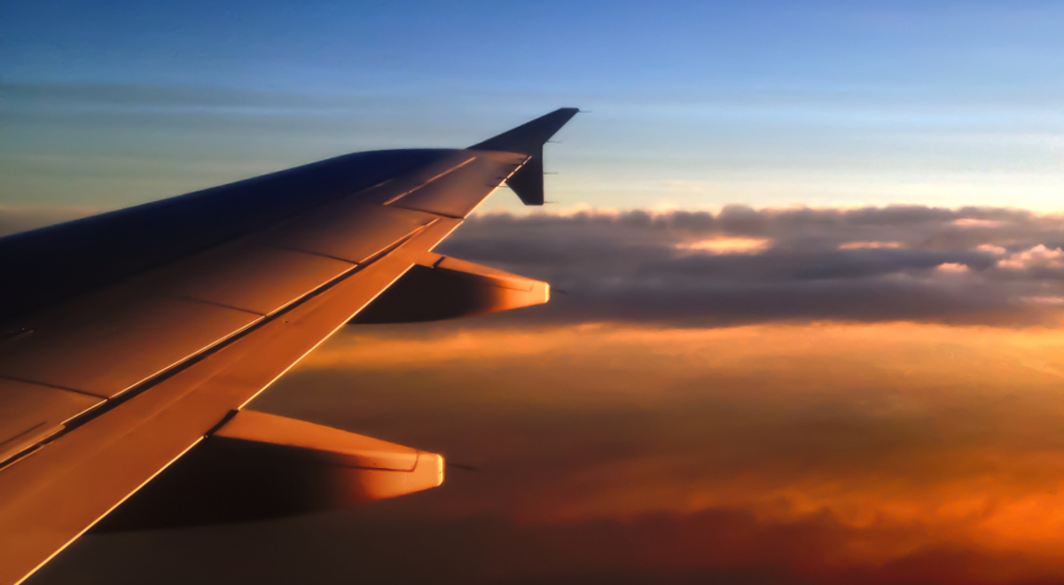 Golden hour's sun rays hitting the plane's right wing